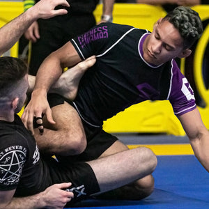 martial artists on mat wearing Gameness BJJ rashguards