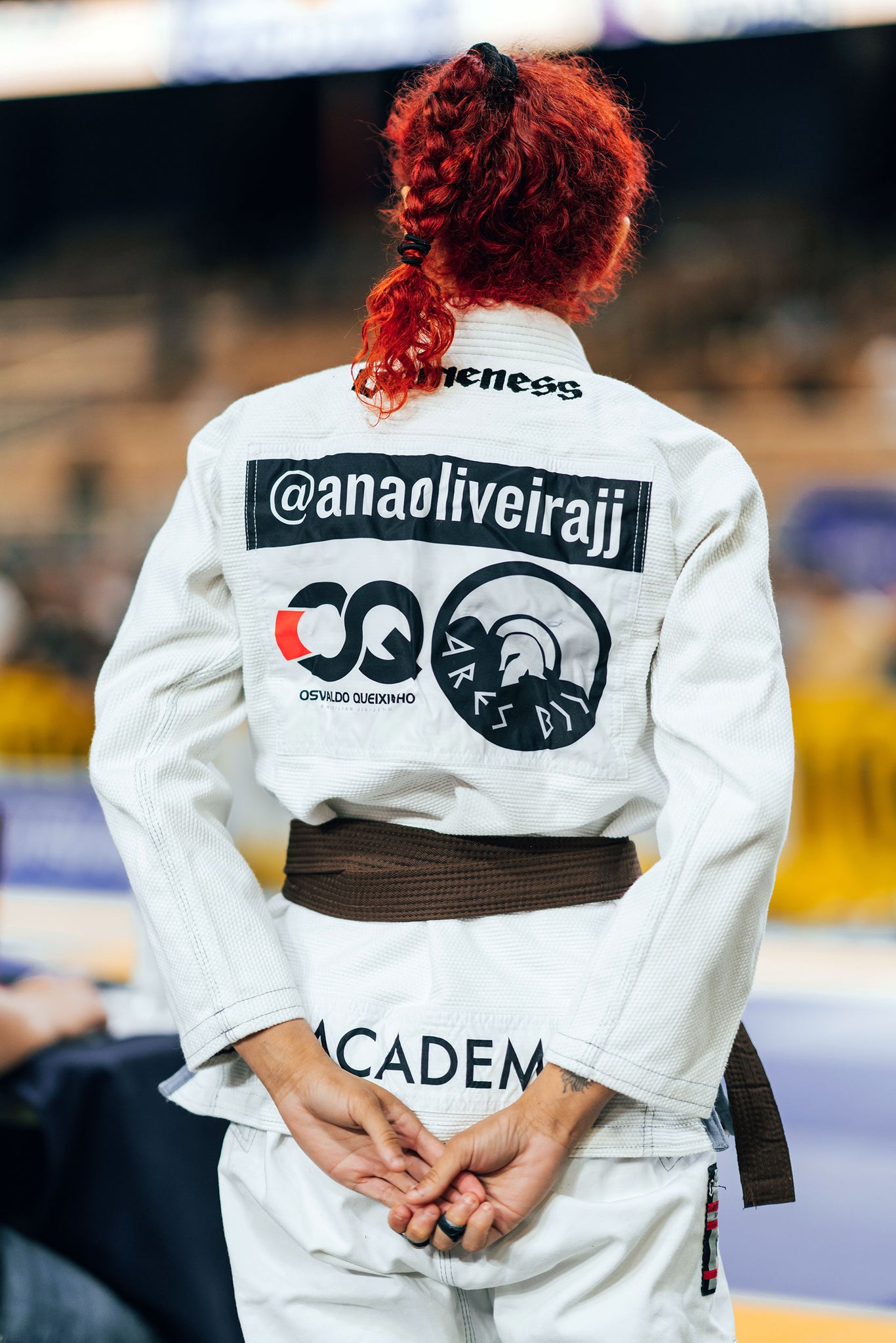 female martial artist in gi with patches